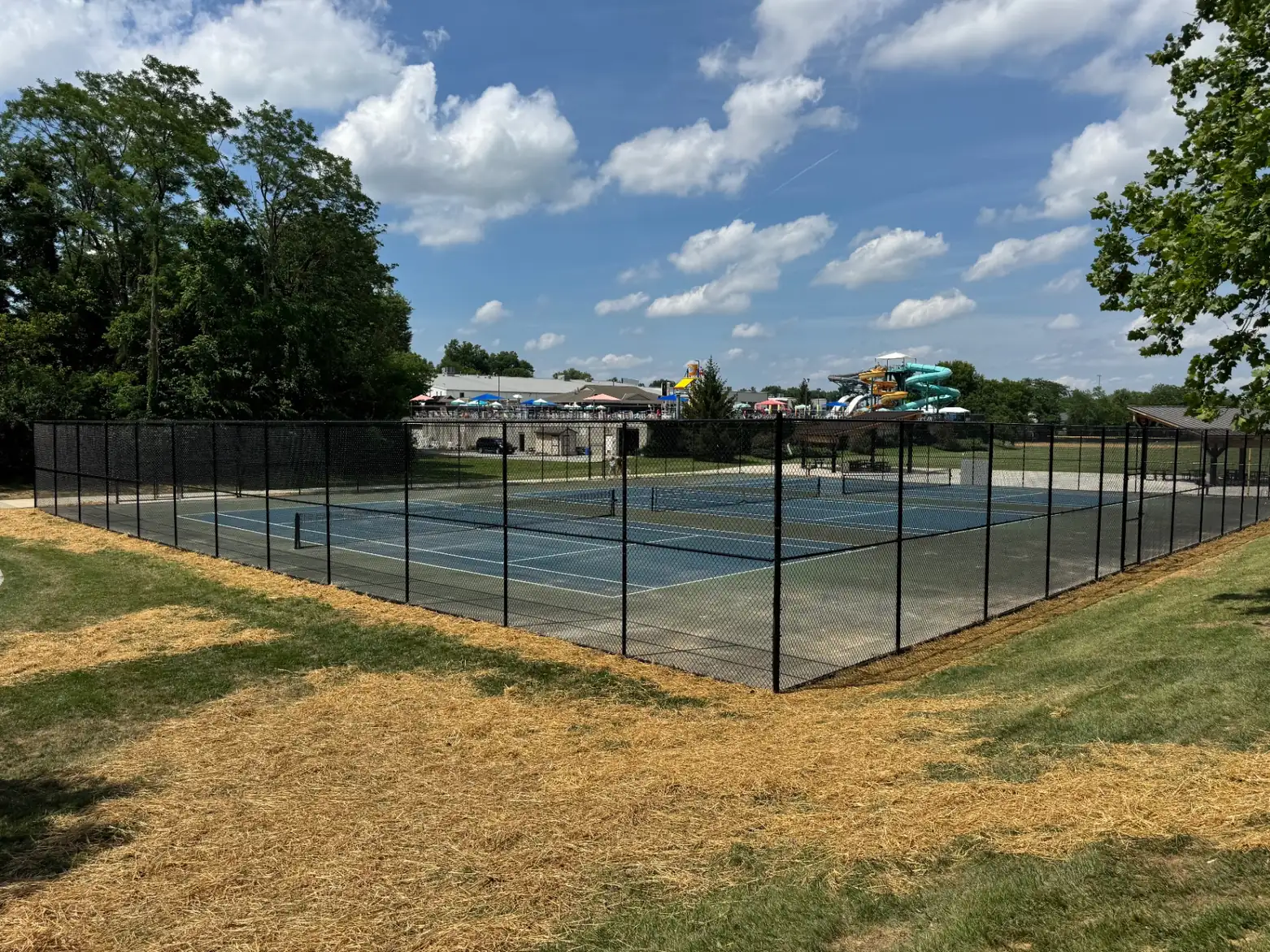 Black chain-link tennis-court enclosure installed by S&S Fencing